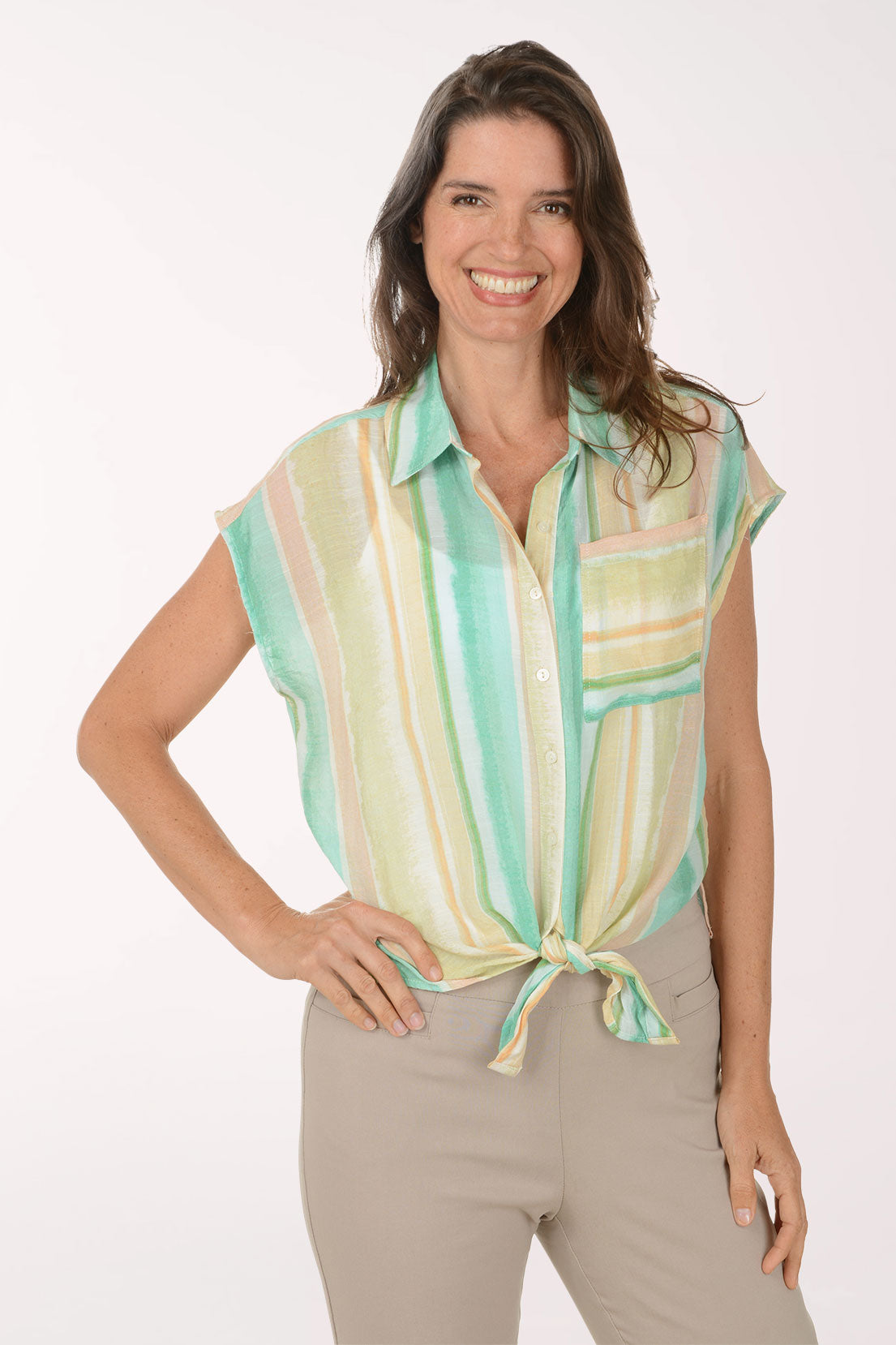 Woman wearing a colorful striped shirt with a white background