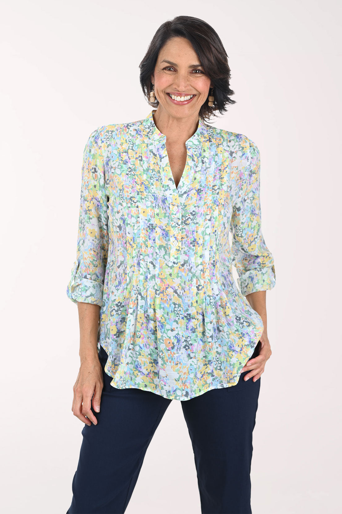 Woman wearing a floral blouse with a plain background