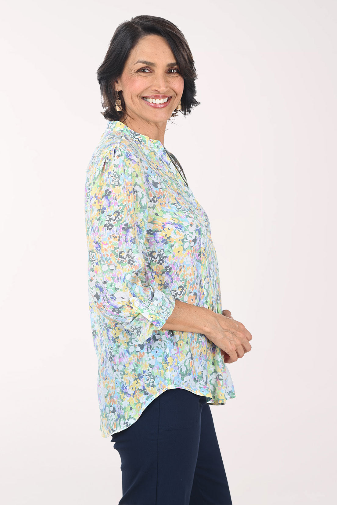 Woman wearing a floral blouse with a plain background