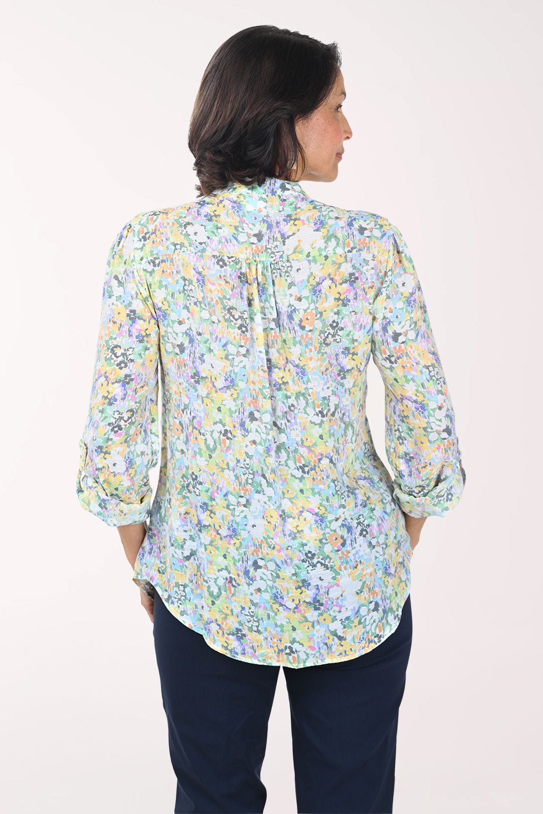 Woman wearing a floral blouse with a plain background