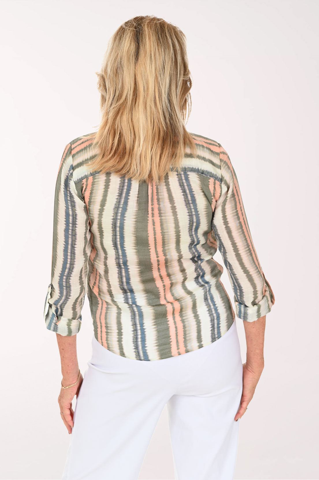 Woman wearing a green striped button down blouse