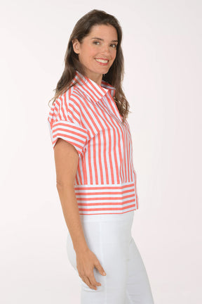 Woman wearing a red and white striped shirt with a white background