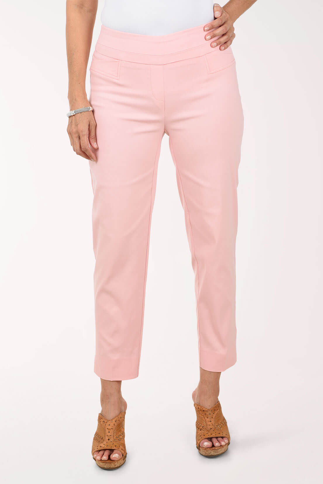 Person wearing light pink pants on a white background