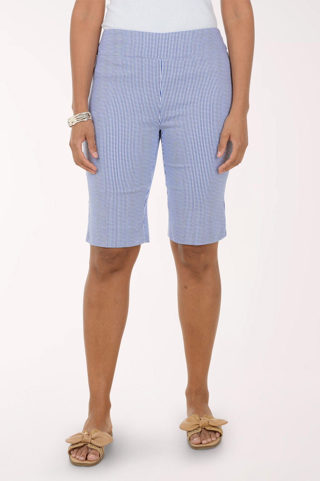 Person wearing blue striped shorts on a white background