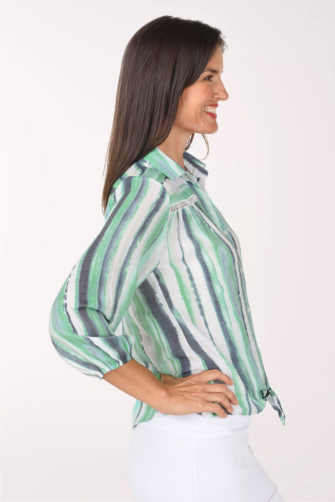Side view of the Green Gulfstream Striped Crochet Detail Shirt with the curved hem tied at the front