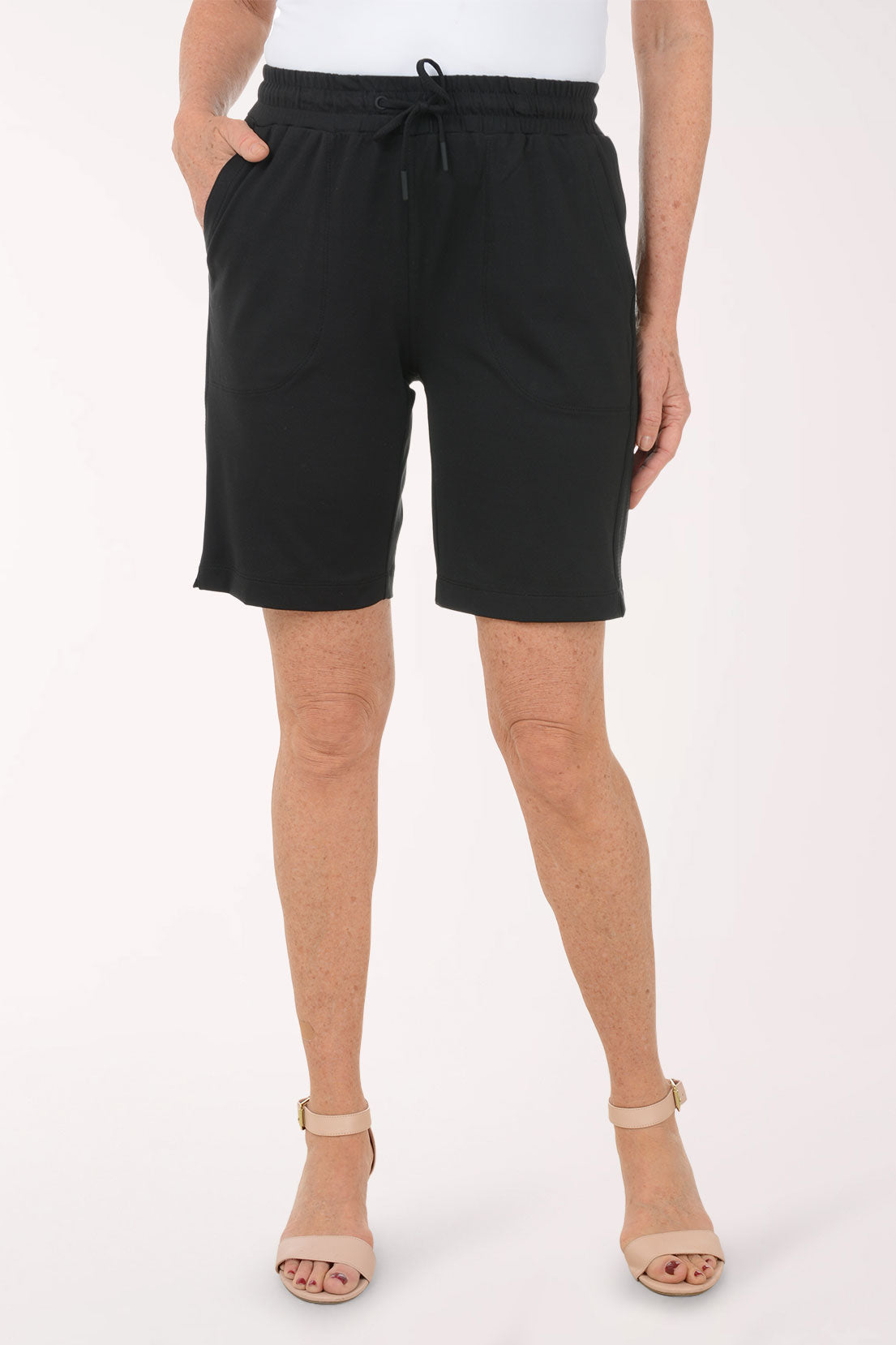 A woman wearing black drawstring shorts.