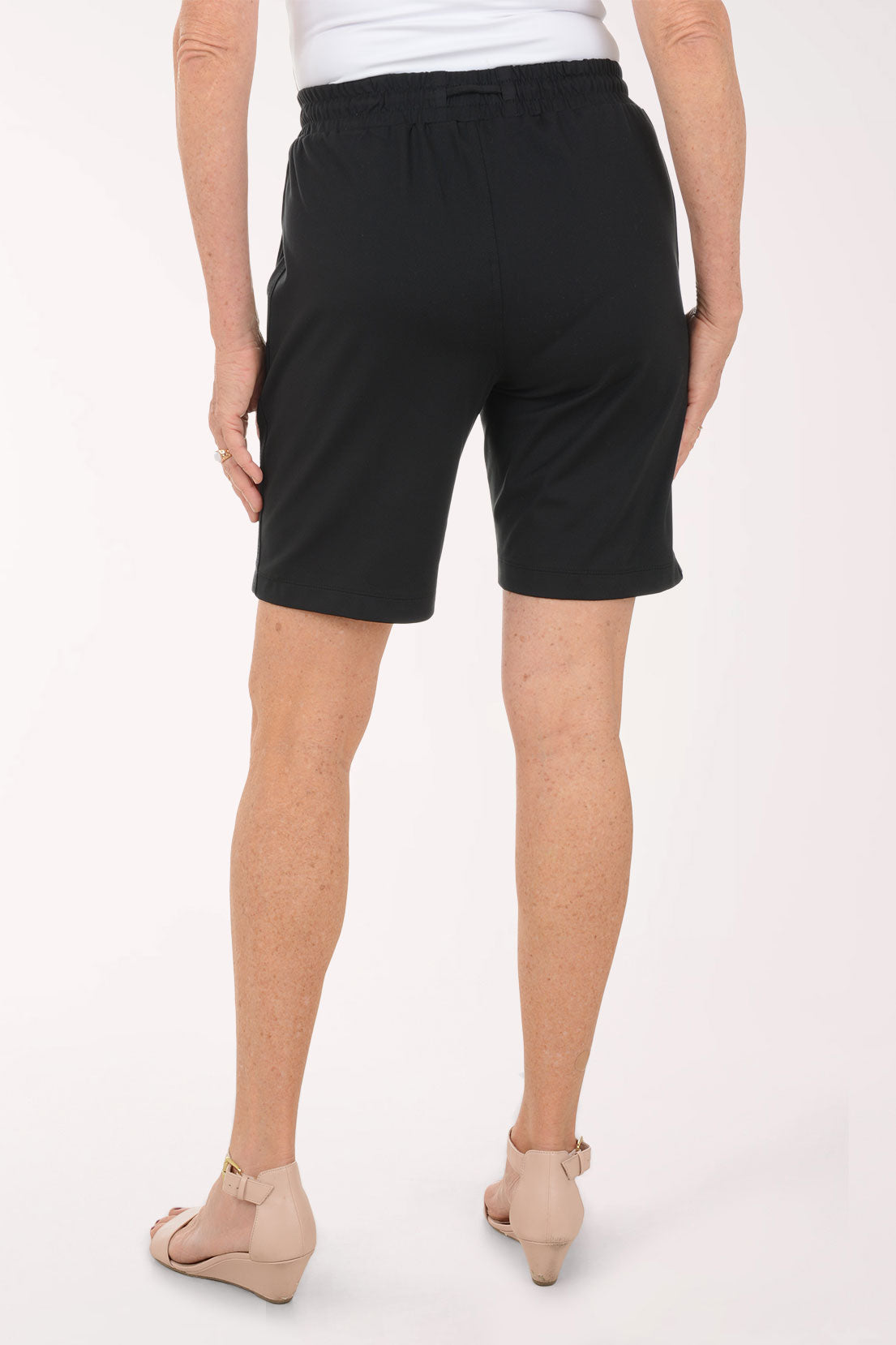 A woman wearing black drawstring shorts.