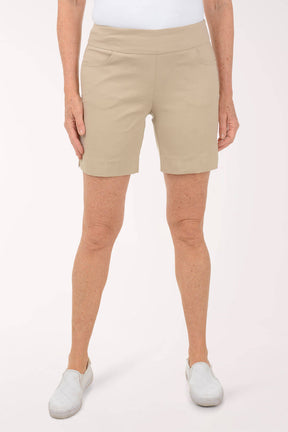 Person wearing beige shorts on a white background