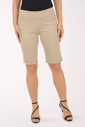 Beige shorts worn by a person on a white background