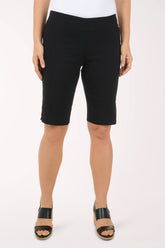 A woman wearing black bermuda shorts.