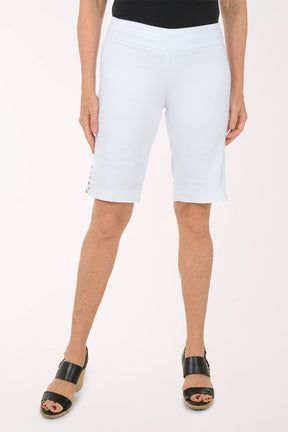 A woman wearing white bermuda shorts.