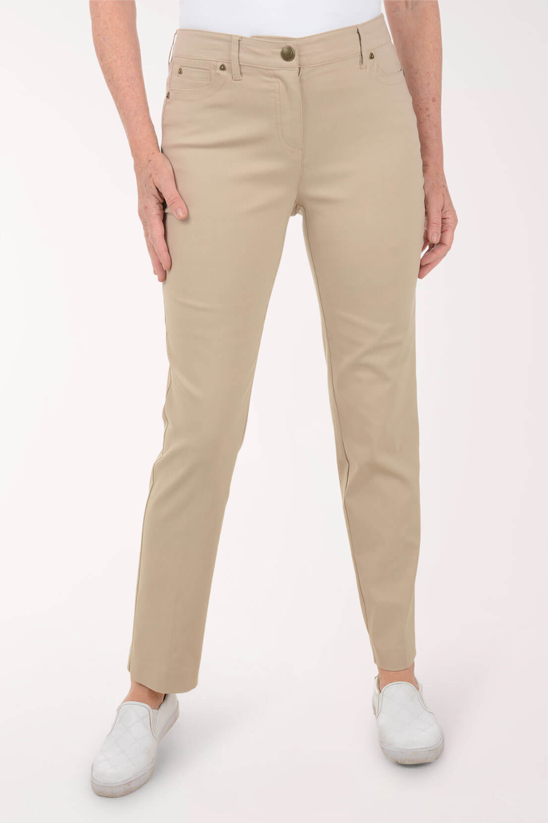 Beige pants worn by a person on a white background