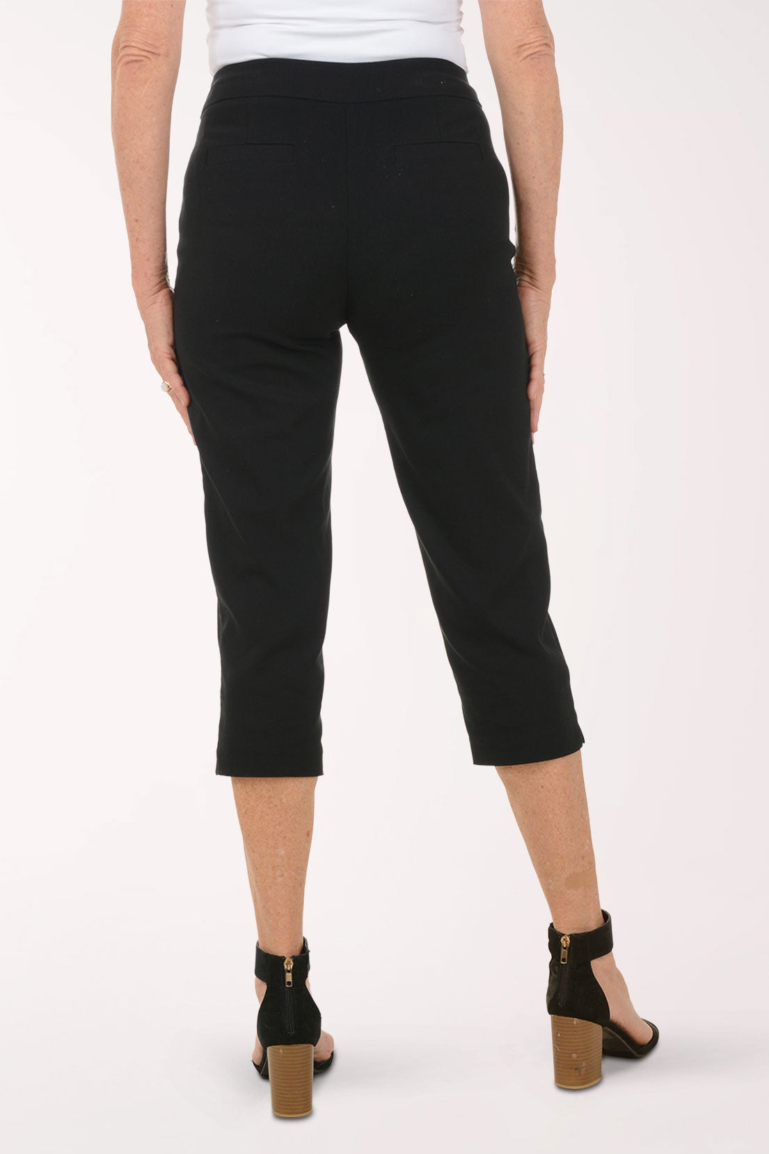 A woman wearing black crop pants.