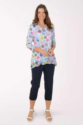 A woman wearing black crop pants.