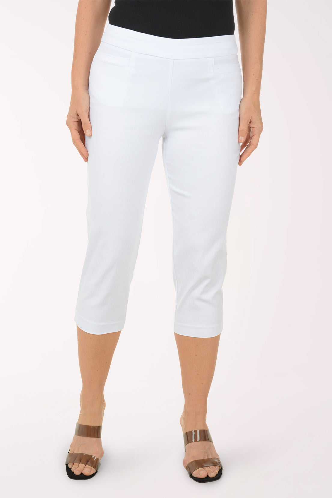 A woman wearing white crop pants.