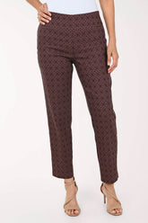 A model wearing a pair of dark brown cropped trousers with a fine geometric pattern, paired with beige high-heeled sandals against a plain white background.