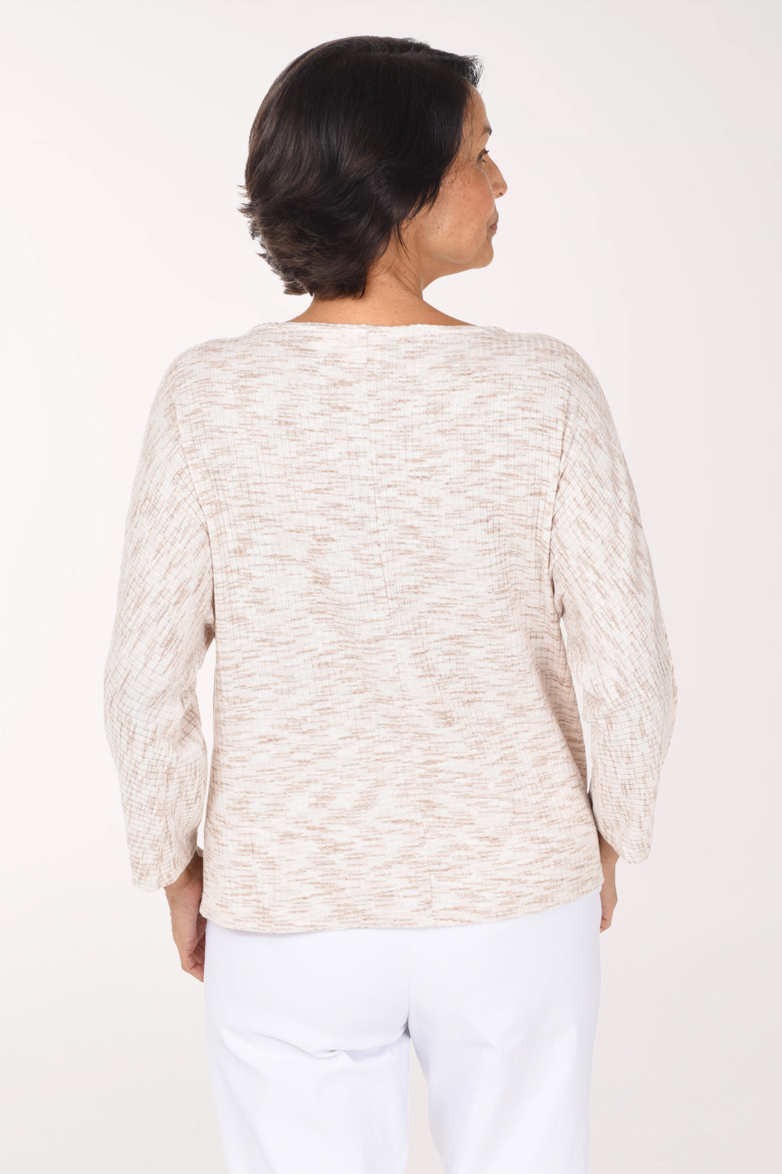 Woman wearing a beige long sleeve sweater