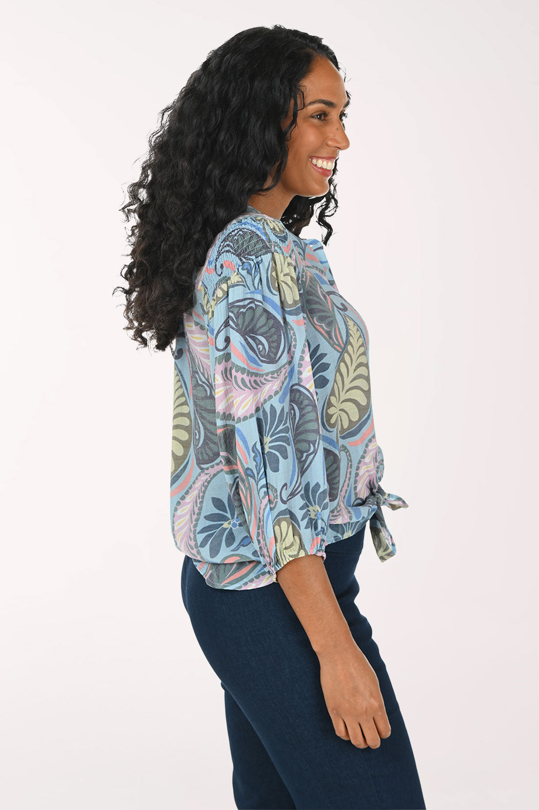 Woman wearing a patterned blouse with a white background