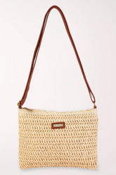 Woven handbag with a brown strap on a white background