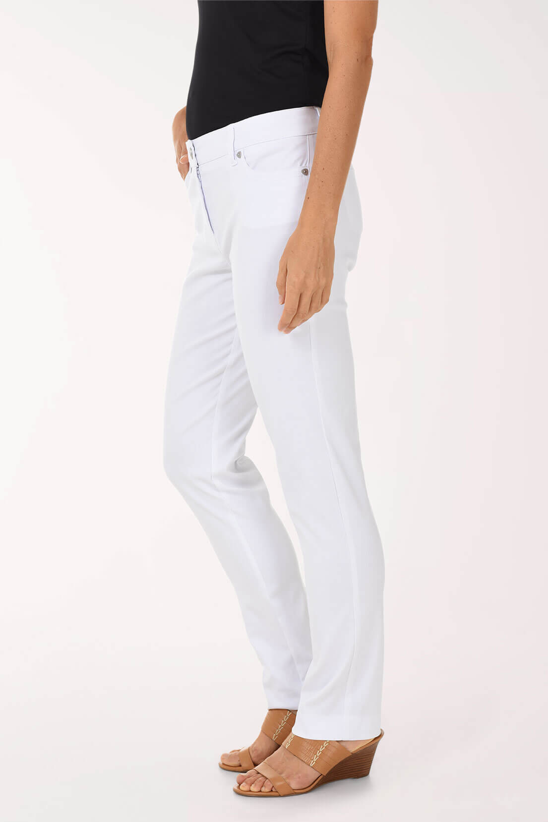 Person wearing white jeans on a plain background