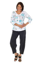 A full length shot of a model wearing a black mineral wash pull-on ankle pants with an elasticized waistband, dual side pockets, and tapered leg design.
